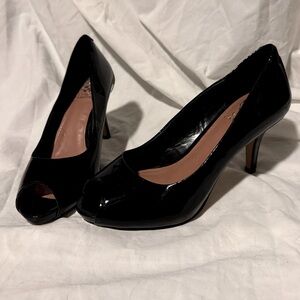 Vince Camuto Kiras black patent leather peep toe heels.